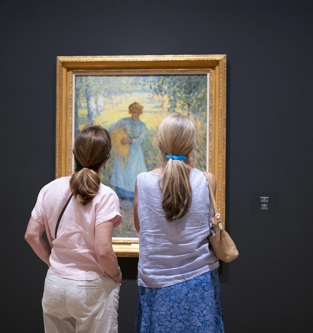 Two members in front The Gleaner by Helen McNicoll.