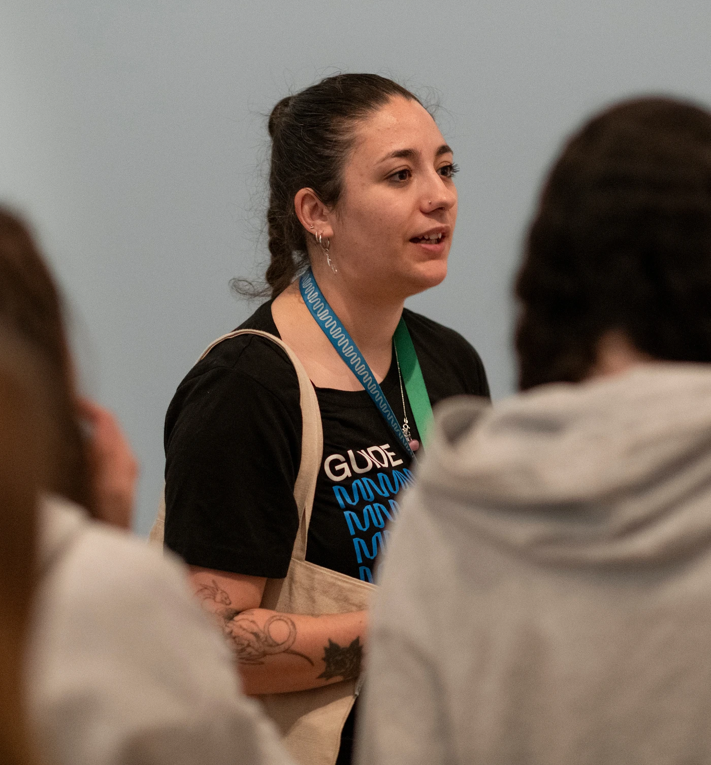 A guide is leading a group of students through the museum