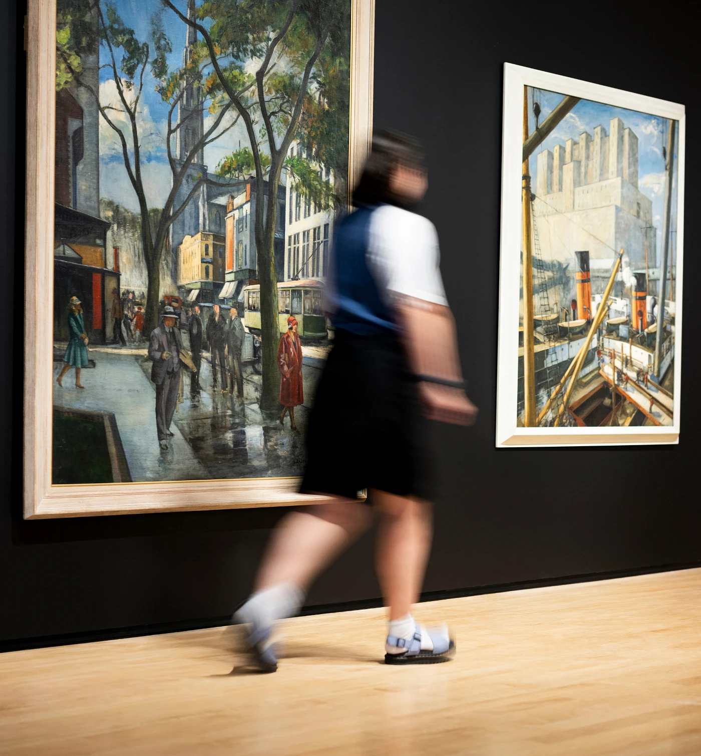 From left to right: Adrien Hébert, Rue Saint-Denis, 1927 (1974.239) and Le Port de Montréal, 1924 (1975.289)
