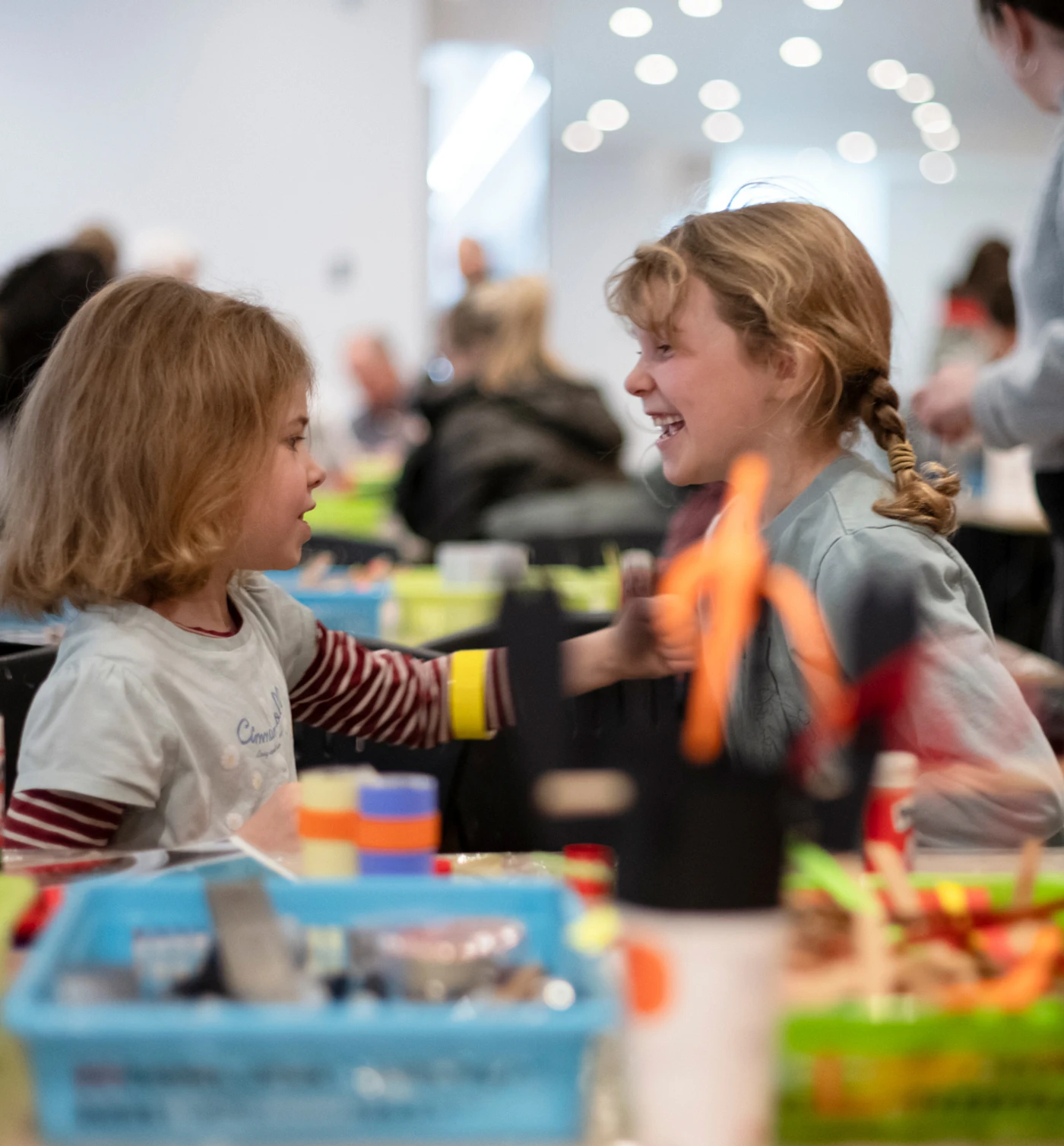 Creative workshop with two children sitting at the table doing crafts at the Musée national des beaux-arts du Québec.