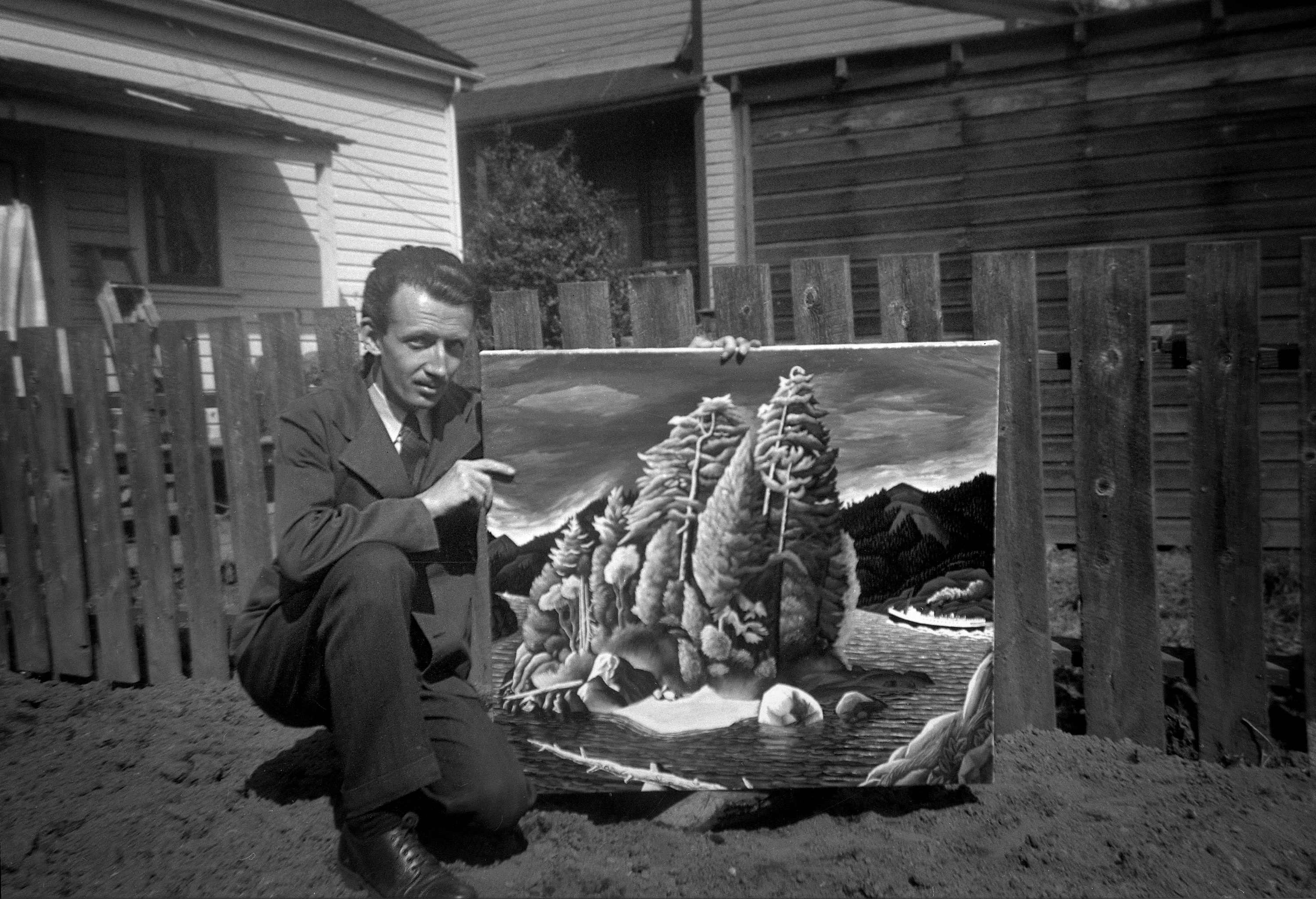 EJH 03b Ed Hughes holding a painting in his yard full ca 1950