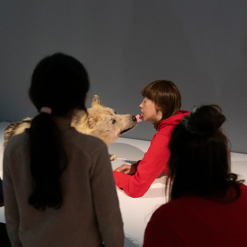 Young visitors in front of a sculpture in the exhibition.