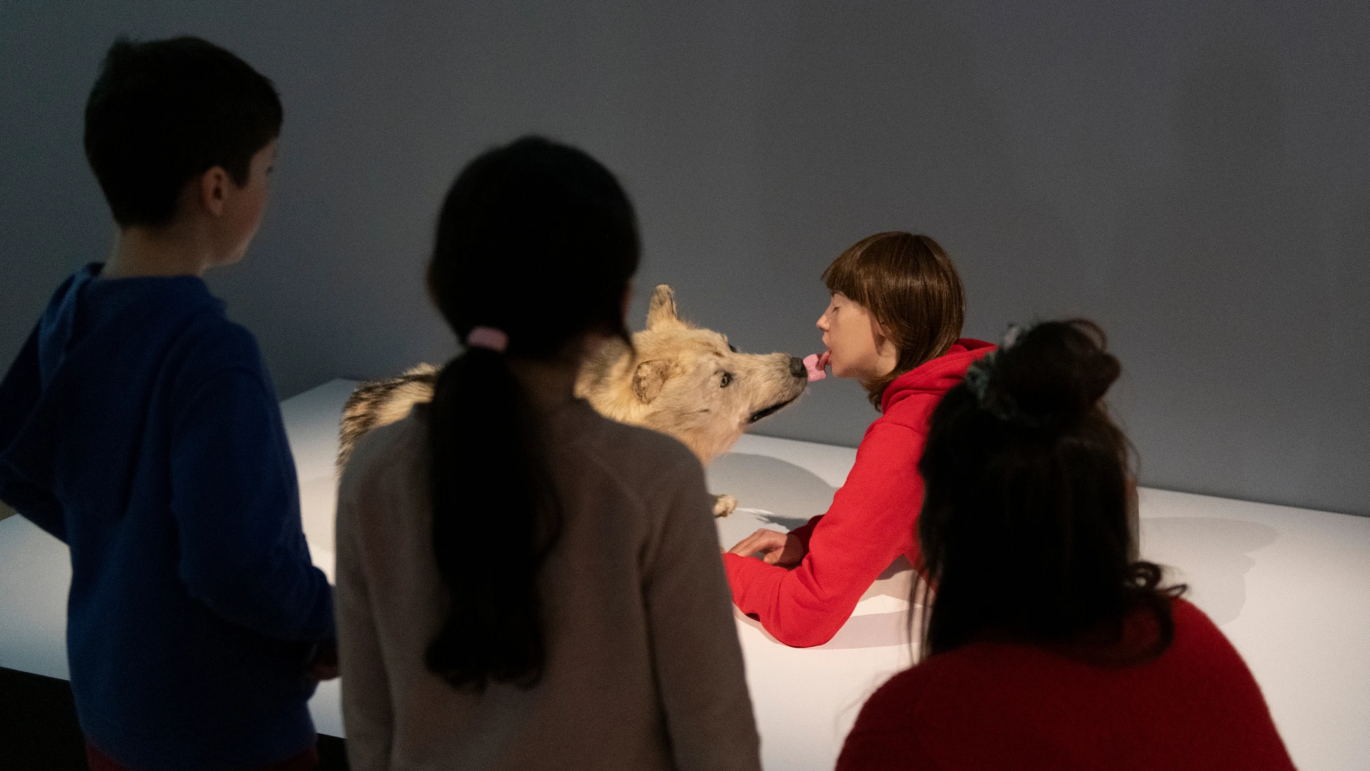 Young visitors in front of a sculpture in the exhibition.