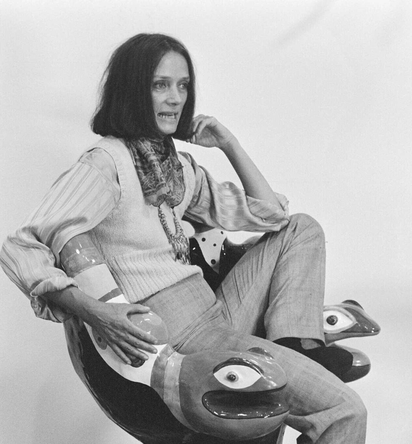Niki de Saint Phalle sitting on one of her armchairs during the installation of her retrospective at the Centre Pompidou